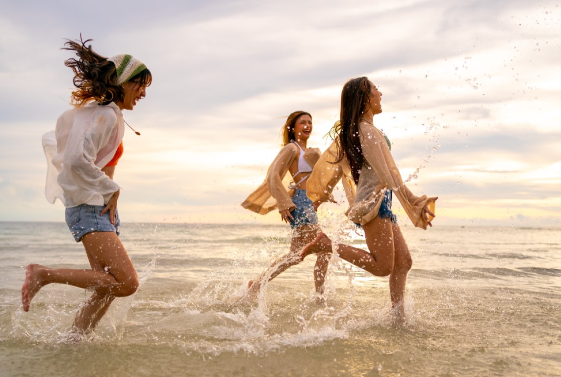 women running through waves